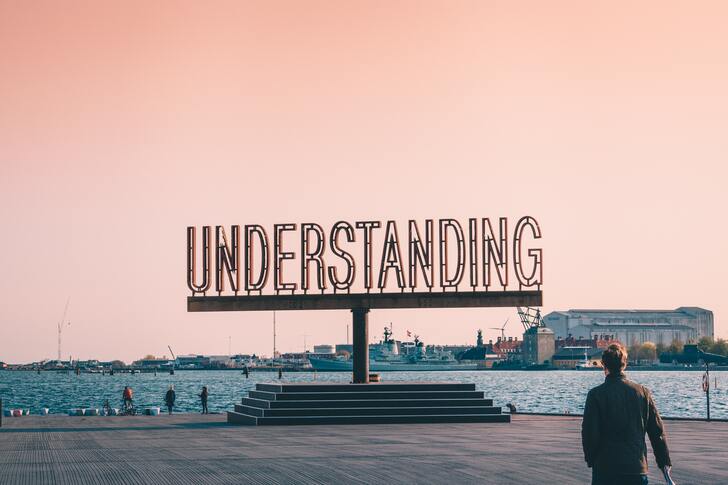 A statue that says understanding on a pier